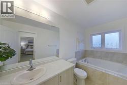Bathroom with a garden tub, vanity, and ensuite bath - 