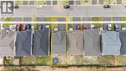 Aerial view of residential area featuring property parcel outlined - 