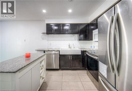 Kitchen featuring appliances with stainless steel finishes, open shelves, recessed lighting, light stone counters, and light tile patterned floors - 20 Bankside Drive, Kitchener, ON - Indoor Photo Showing Kitchen With Upgraded Kitchen