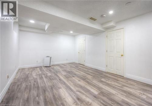 Finished basement featuring light wood-style flooring and recessed lighting - 20 Bankside Drive, Kitchener, ON - Indoor Photo Showing Other Room