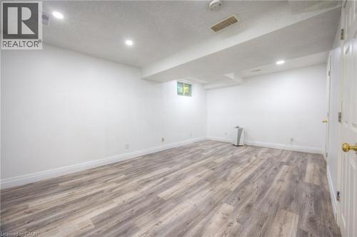 Below grade area featuring light wood-style flooring, a textured ceiling, and recessed lighting - 20 Bankside Drive, Kitchener, ON - Indoor Photo Showing Other Room