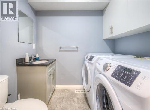 Washroom with independent washer and dryer and light tile patterned floors - 20 Bankside Drive, Kitchener, ON - Indoor Photo Showing Laundry Room