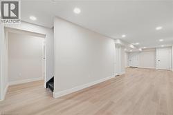 Finished basement featuring recessed lighting and light hardwood flooring - 