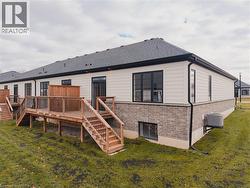 Back of end-unit with stairs, a yard, and a deck - 