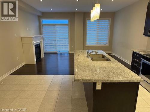 58 Heming Trail, Ancaster, ON - Indoor Photo Showing Kitchen With Fireplace With Double Sink