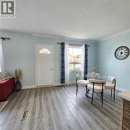 Entrance foyer featuring crown molding and wood finished floors - 