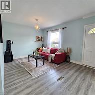 Living room featuring healthy amount of natural light and light wood-style flooring - 