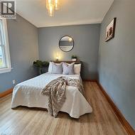 Bedroom with baseboards and wood finished floors - 