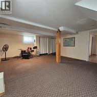 Basement featuring carpet and baseboards - 