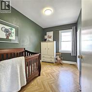 Bedroom featuring baseboards and a nursery area - 