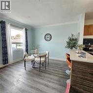 Dining space featuring ornamental molding and light wood finished floors - 