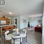 Dining space featuring dark wood-style floors and baseboards - 