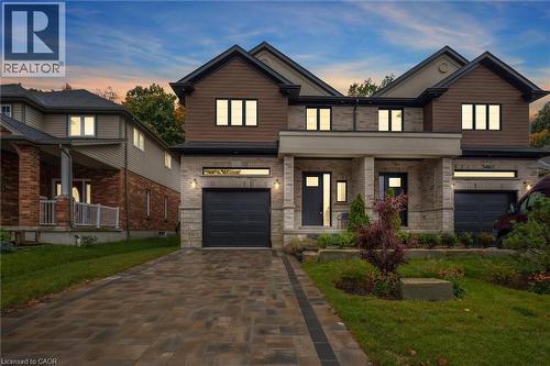 Semi-detached home with a 1-car garage and paver stone driveway & walkway - 548 Peach Blossom Court, Kitchener, ON - Outdoor With Facade