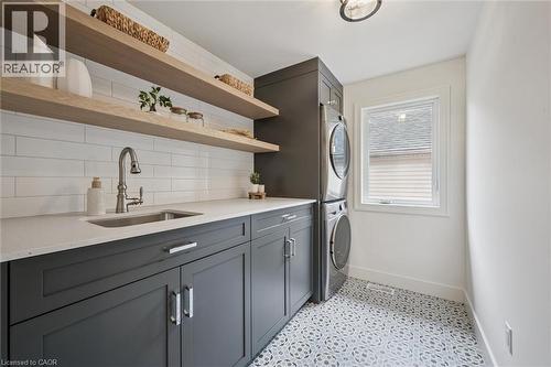 Second floor laundry room with a stackable washer/dryer, sink and plenty of storage and counterspace - 548 Peach Blossom Court, Kitchener, ON - Indoor