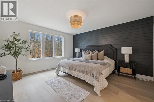 Owner's Suite which includes room for a king-size bed, oversize window with rear yard forest views & a feature wall - 548 Peach Blossom Court, Kitchener, ON - Indoor Photo Showing Bedroom