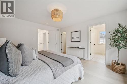 Owner's suite which includes a 4-pc ensuite and large walk-in closet with custom built-ins - 548 Peach Blossom Court, Kitchener, ON - Indoor Photo Showing Bedroom