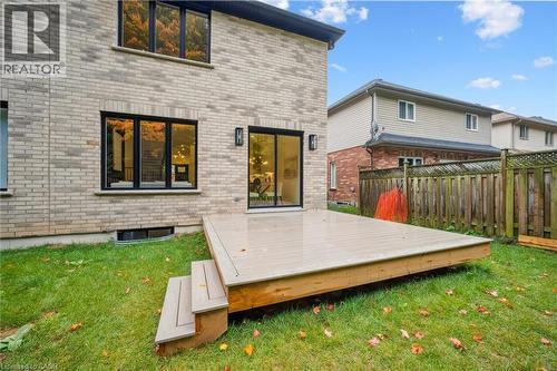 Rear yard is partially fenced and includes a vinyl deck, plenty of yard space and backs onto 8 acres of forest - 548 Peach Blossom Court, Kitchener, ON - Outdoor With Exterior