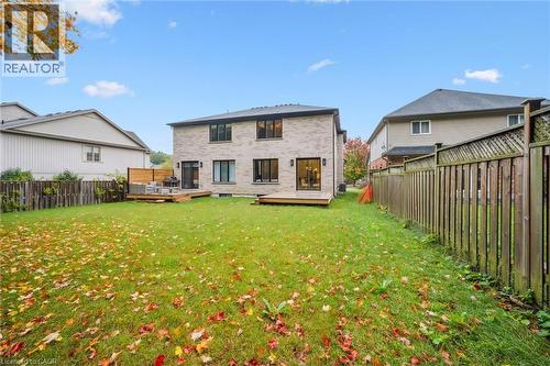 Rear yard is partially fenced and includes a vinyl deck, plenty of yard space and backs onto 8 acres of forest - 548 Peach Blossom Court, Kitchener, ON - Outdoor With Backyard With Exterior