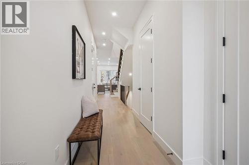 Bright entry with 10' ceilings, an entry closet and convenient access to the 2-pc powder room - 548 Peach Blossom Court, Kitchener, ON - Indoor Photo Showing Other Room