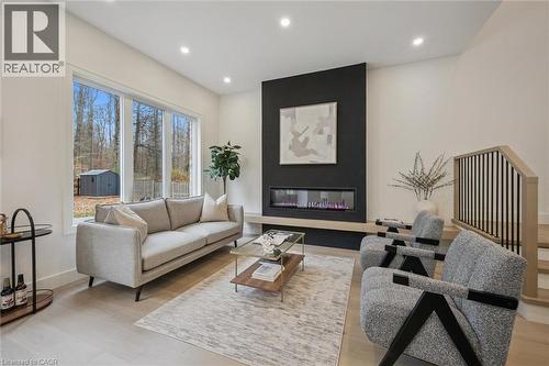 Open-concept kitchen, living room & dinette with large windows & 10' ceilings - 548 Peach Blossom Court, Kitchener, ON - Indoor Photo Showing Living Room With Fireplace