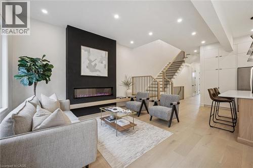 Open-concept kitchen, living room & dinette with large windows & 10' ceilings - 548 Peach Blossom Court, Kitchener, ON - Indoor Photo Showing Living Room With Fireplace