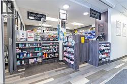 Miscellaneous room featuring a paneled ceiling and light wood-style floors - 