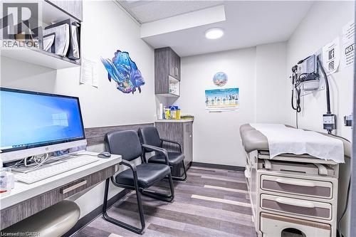 Office space featuring light wood-type flooring and built in study area - 10 Main Street, Mississauga, ON 