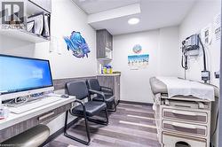 Office space featuring light wood-type flooring and built in study area - 