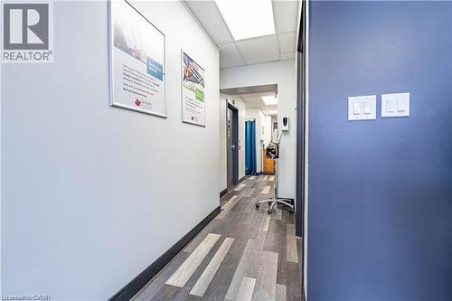Corridor with dark wood-style flooring and a paneled ceiling - 10 Main Street, Mississauga, ON 