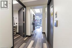 Hallway with dark wood-style floors and baseboards - 