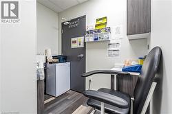 Laundry room with dark wood-style flooring and heating unit - 