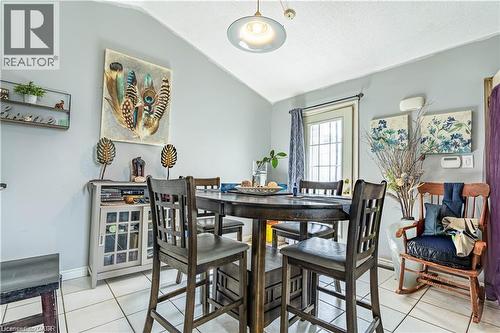 Dining room with light tile patterned floors and vaulted ceiling - 10 Main Street, Mississauga, ON 