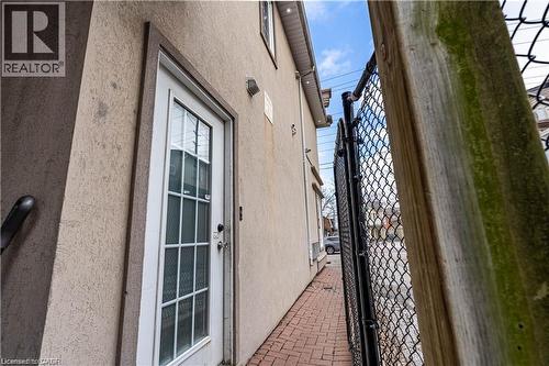 View of side of property featuring stucco siding and a gate - 10 Main Street, Mississauga, ON 