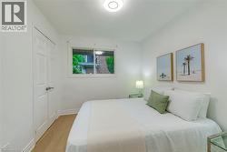 Bedroom with light wood-type flooring and a closet - 