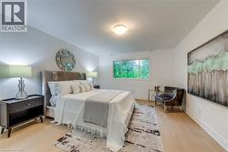 Bedroom with light wood-type flooring and baseboards - 