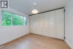 Unfurnished bedroom featuring light wood finished floors and baseboards - 