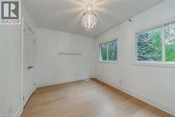 Unfurnished bedroom with light wood-style flooring and a closet - 