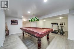 Recreation room featuring billiards, light wood-style floors, and recessed lighting - 