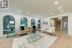 Living room featuring recessed lighting, stairs, light wood-style floors, and crown molding - 