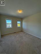 Carpeted spare room with baseboards - 