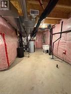 Unfinished basement with gas water heater, heating unit, and electric panel - 