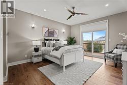 Bedroom featuring access to exterior, hardwood / wood-style floors, a ceiling fan, and recessed lighting - 