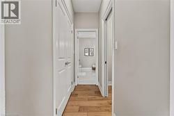 Hall with baseboards and light wood-style flooring - 