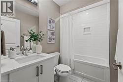 Full bath with vanity, shower / bathtub combination with curtain, and light marble finish flooring - 