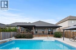 View of pool with a fenced backyard and a patio - 