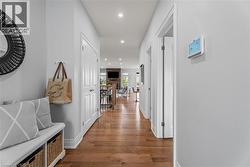 Hall featuring an upstairs landing, recessed lighting, and wood-type flooring - 