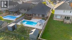View of swimming pool with a residential view, a patio, a shed, and a deck - 