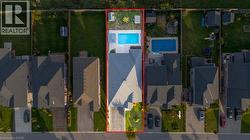 Aerial view of residential area featuring a pool area and property parcel outlined - 