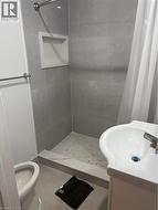 Full bath featuring a stall shower, vanity, and tile patterned flooring - 