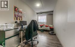 Office with a textured ceiling and hardwood / wood-style flooring - 